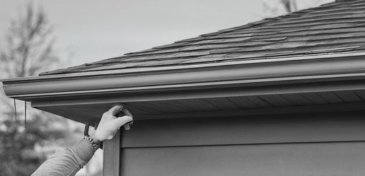 New seamless gutter installed along a roofline